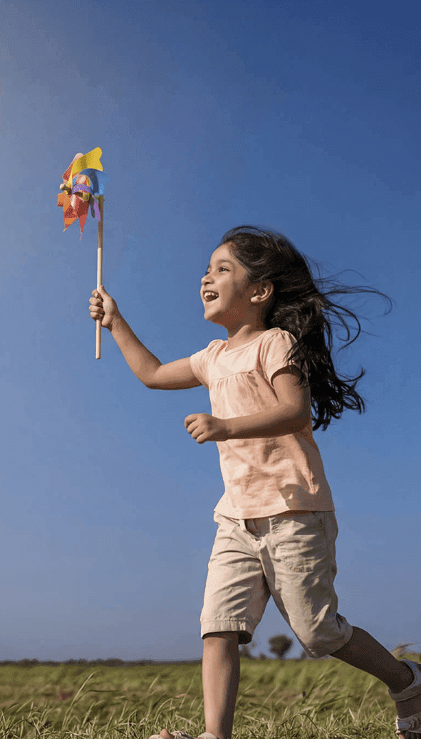 Happy child playing with pinwheel